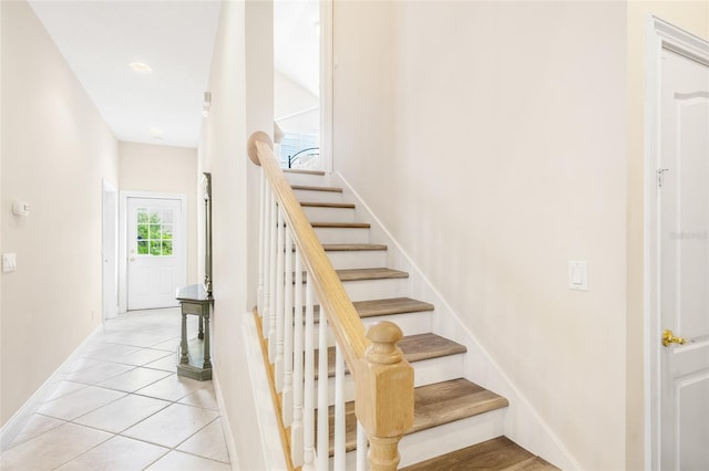 staircase with tile patterned flooring and baseboards