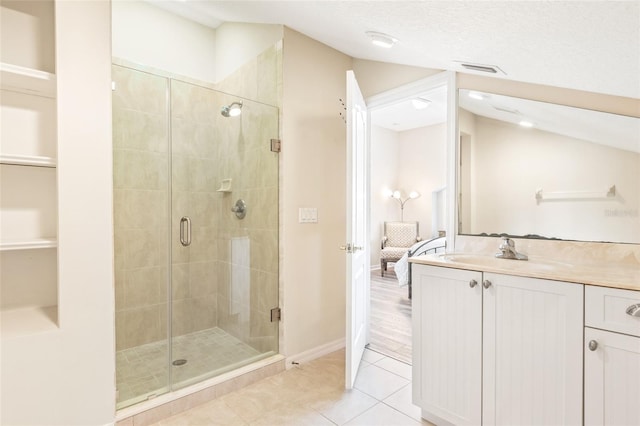 ensuite bathroom with ensuite bathroom, visible vents, vanity, a shower stall, and tile patterned floors