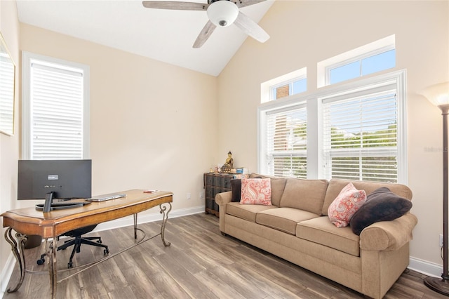 office featuring high vaulted ceiling, ceiling fan, baseboards, and wood finished floors