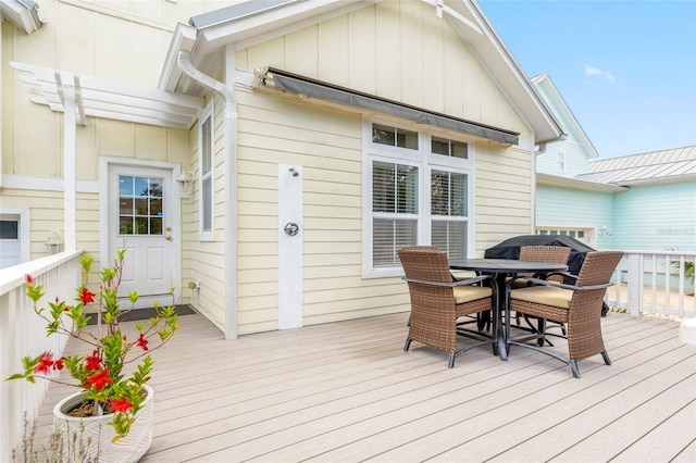 wooden deck featuring outdoor dining space