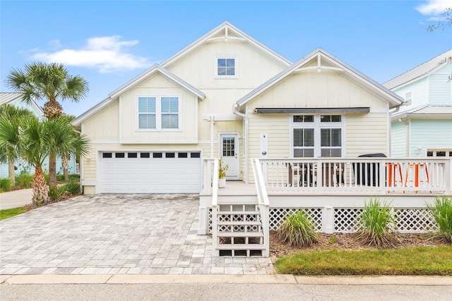 view of front of house featuring an attached garage, decorative driveway, and board and batten siding