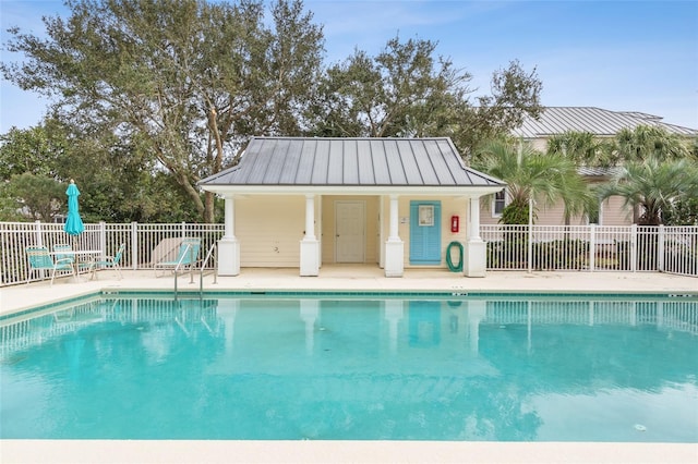 community pool featuring a patio and fence