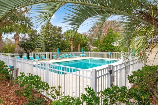 community pool featuring fence and a patio