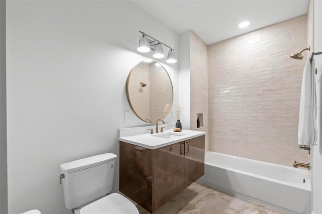 bathroom with vanity, bathtub / shower combination, and toilet