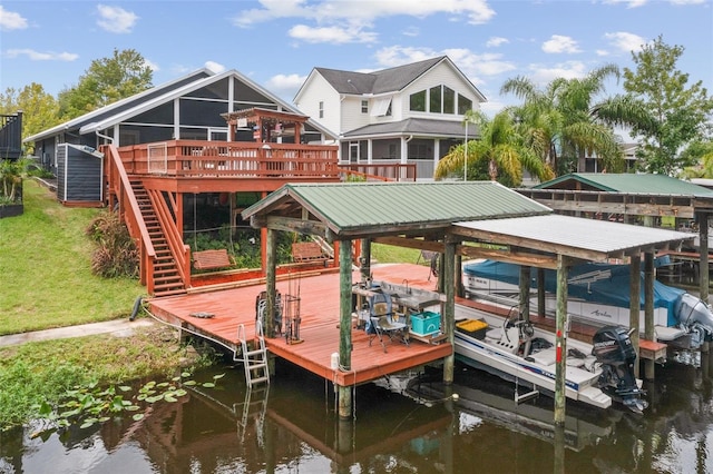 view of dock with a yard and a deck with water view