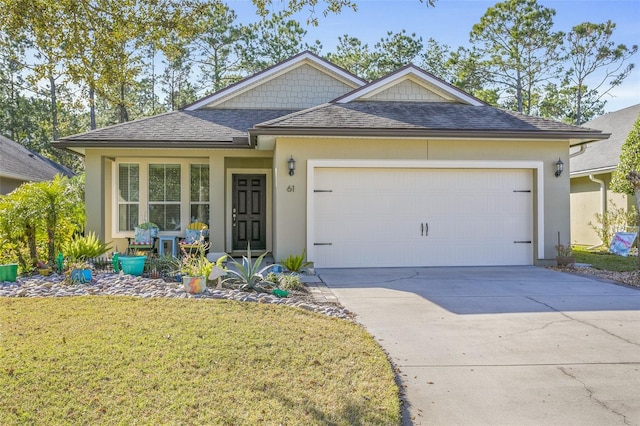 view of front of property with a garage and a front yard