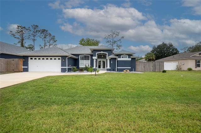 view of front of house with a garage and a front lawn