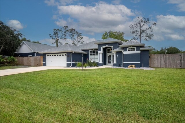 view of front of house featuring a garage and a front lawn