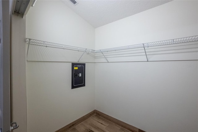 walk in closet featuring lofted ceiling and wood-type flooring