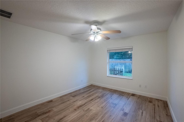 unfurnished room featuring a textured ceiling, ceiling fan, and light hardwood / wood-style floors