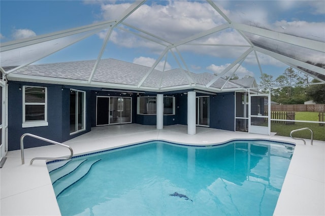 view of swimming pool featuring a patio area and glass enclosure