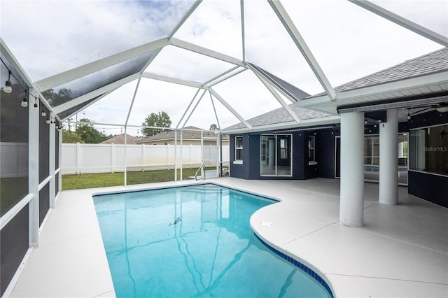 view of swimming pool with a lanai and a patio area