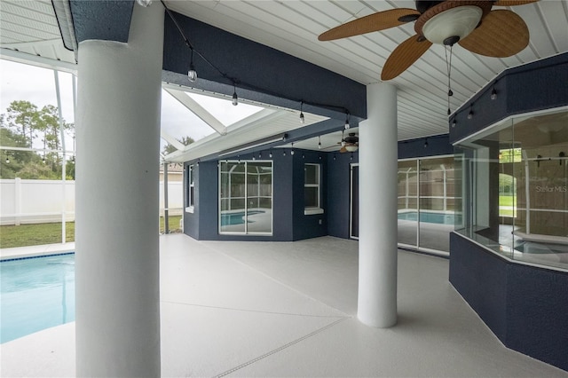 view of patio with a fenced in pool and ceiling fan