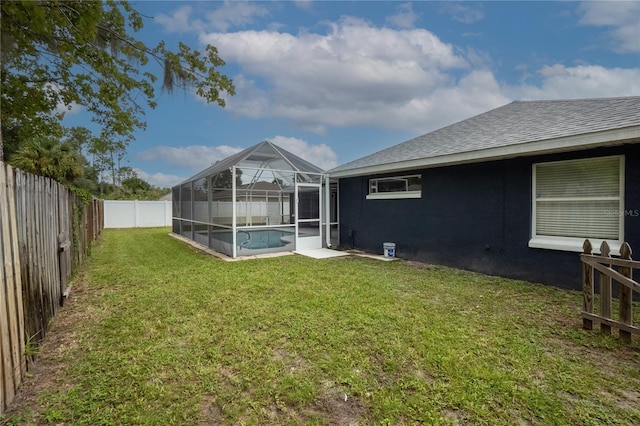 view of yard featuring a fenced in pool and a lanai