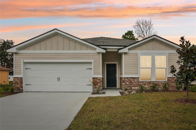 view of front of home with a yard and a garage