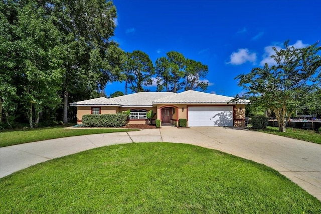 single story home with driveway, stucco siding, a garage, and a front yard