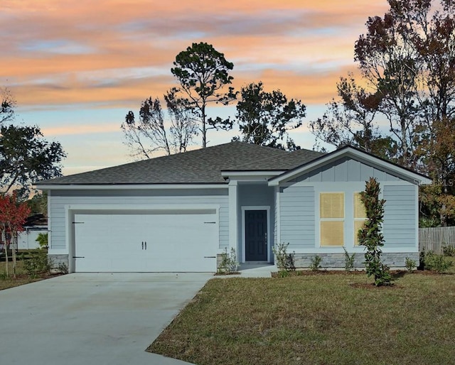 view of front facade featuring a lawn and a garage