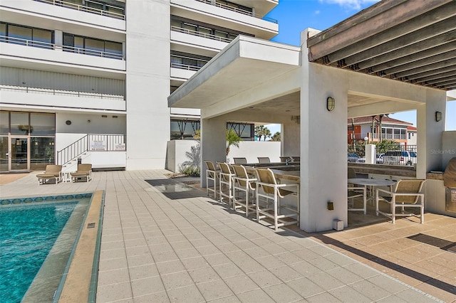 view of patio / terrace with a balcony and exterior bar