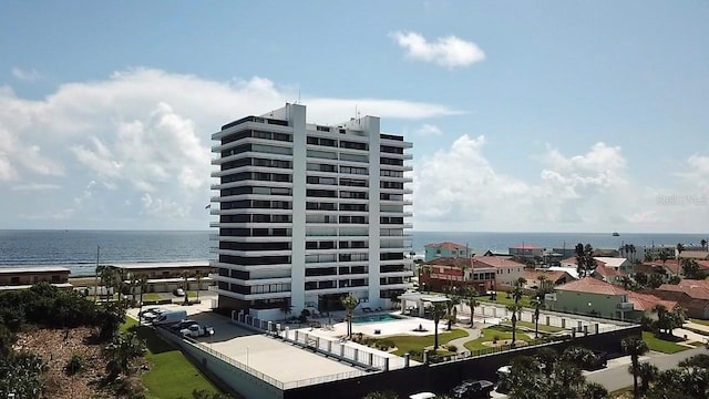 view of property featuring a water view and a community pool