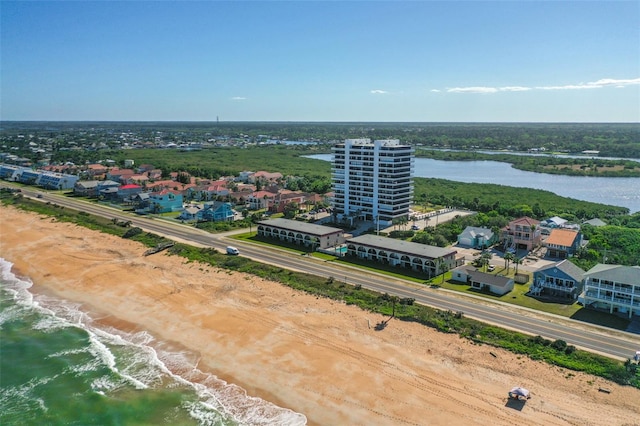 birds eye view of property with a beach view and a water view