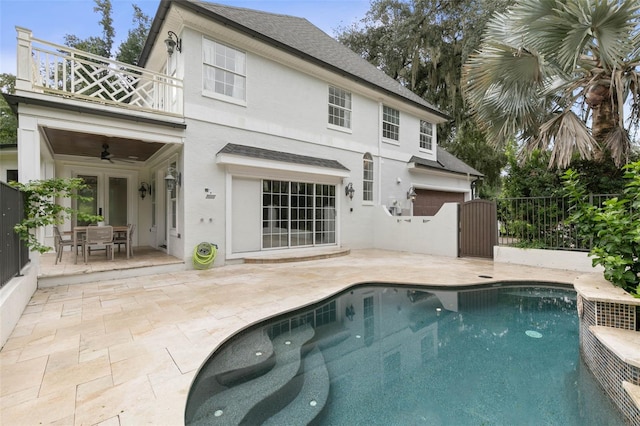 back of property with a patio, ceiling fan, and a fenced in pool