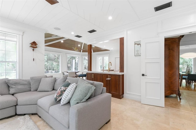 living room with ceiling fan, wood ceiling, and sink