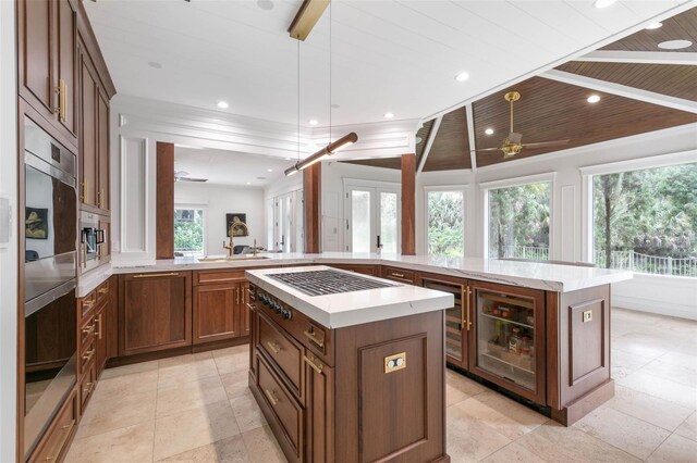 kitchen with ceiling fan, plenty of natural light, and a kitchen island