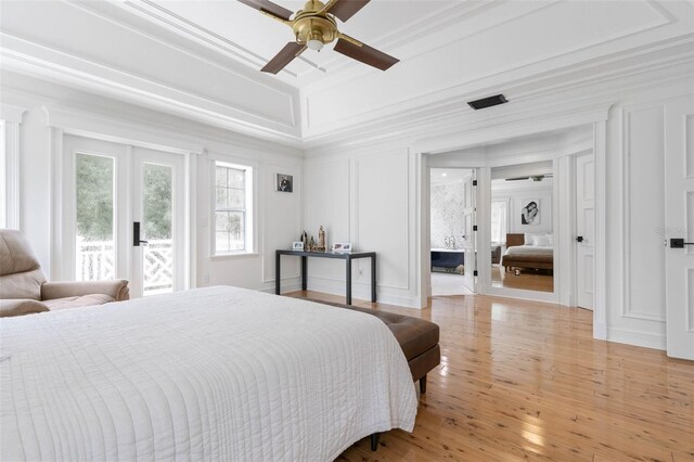 bedroom featuring light hardwood / wood-style flooring, ceiling fan, access to exterior, and crown molding