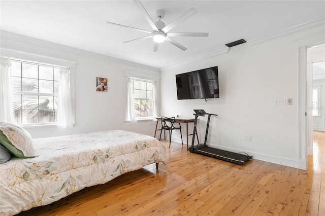 bedroom with ceiling fan, hardwood / wood-style flooring, and crown molding