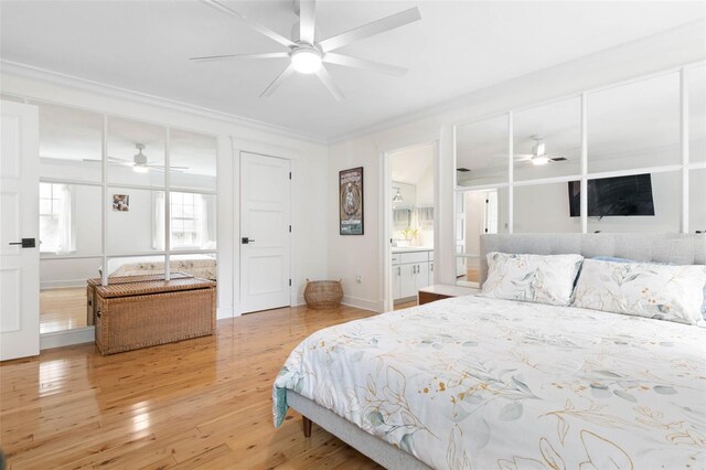 bedroom featuring ornamental molding, hardwood / wood-style floors, ceiling fan, and ensuite bathroom