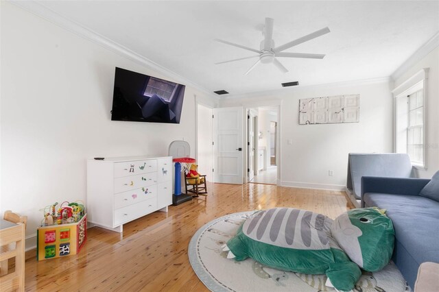 living room with ceiling fan, light hardwood / wood-style flooring, and ornamental molding