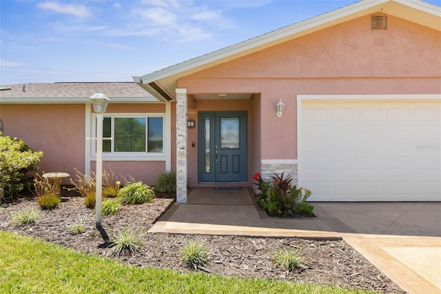 view of exterior entry with a garage