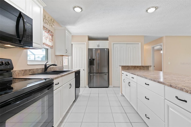 kitchen with black appliances, a textured ceiling, white cabinetry, and sink