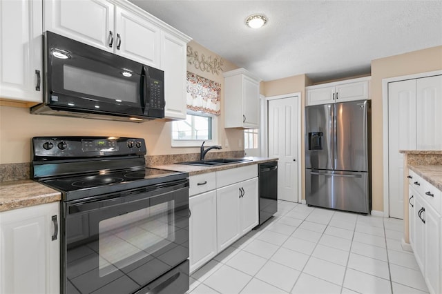 kitchen featuring white cabinetry, a textured ceiling, light tile patterned floors, black appliances, and sink