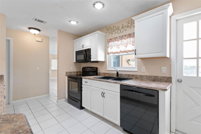 kitchen featuring white cabinets, light tile patterned floors, sink, black appliances, and a textured ceiling