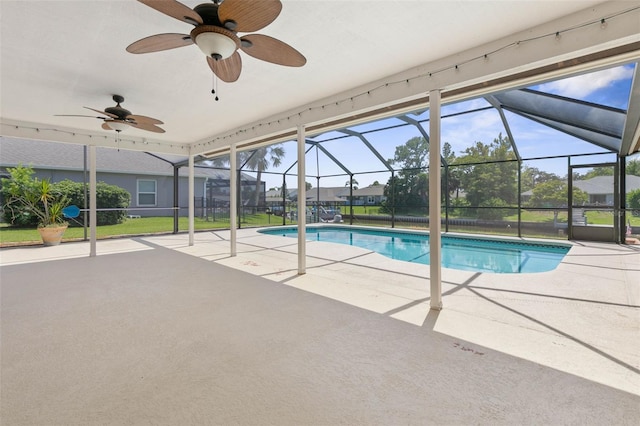 view of swimming pool with a lanai, ceiling fan, and a patio area