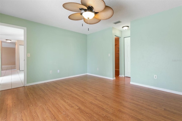 unfurnished room with ceiling fan and hardwood / wood-style floors