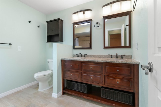 bathroom with vanity, toilet, and tile patterned floors