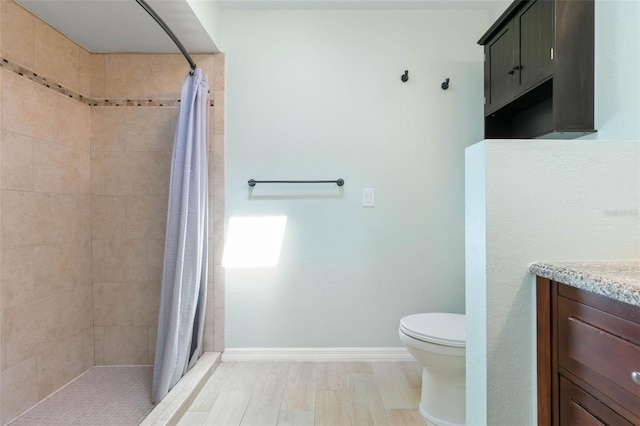 bathroom with vanity, toilet, a shower with shower curtain, and hardwood / wood-style flooring