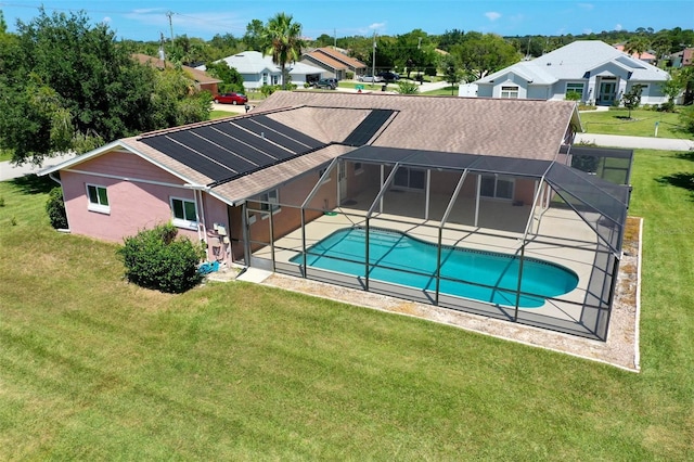 view of swimming pool featuring a lawn, a lanai, and a patio