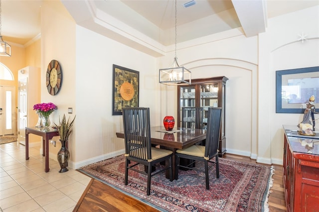 tiled dining area featuring a high ceiling