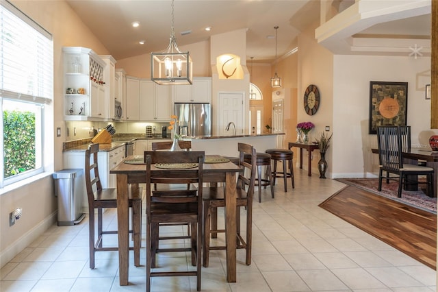 dining space with light tile patterned floors and a notable chandelier