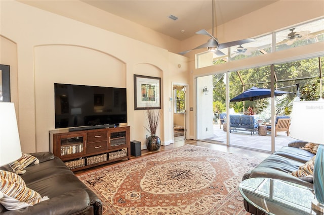 living room featuring wood-type flooring and ceiling fan