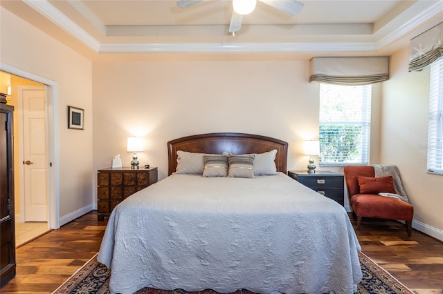 bedroom with a raised ceiling, ceiling fan, and dark hardwood / wood-style flooring