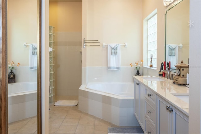 bathroom with vanity, a wealth of natural light, independent shower and bath, and tile patterned floors