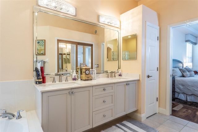 bathroom with a bath, hardwood / wood-style flooring, and vanity