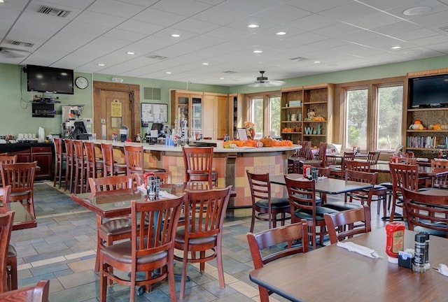 tiled dining area featuring ceiling fan