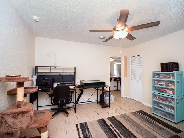 office featuring ceiling fan, a textured ceiling, and light tile patterned floors