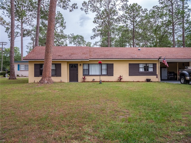 362 E Minnesota Ave, Macclenny, FL 32063 - ranch-style home with a front lawn, an attached carport, and stucco siding