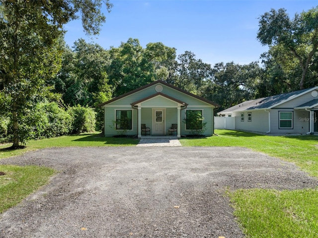 bungalow-style house featuring a porch and a front lawn